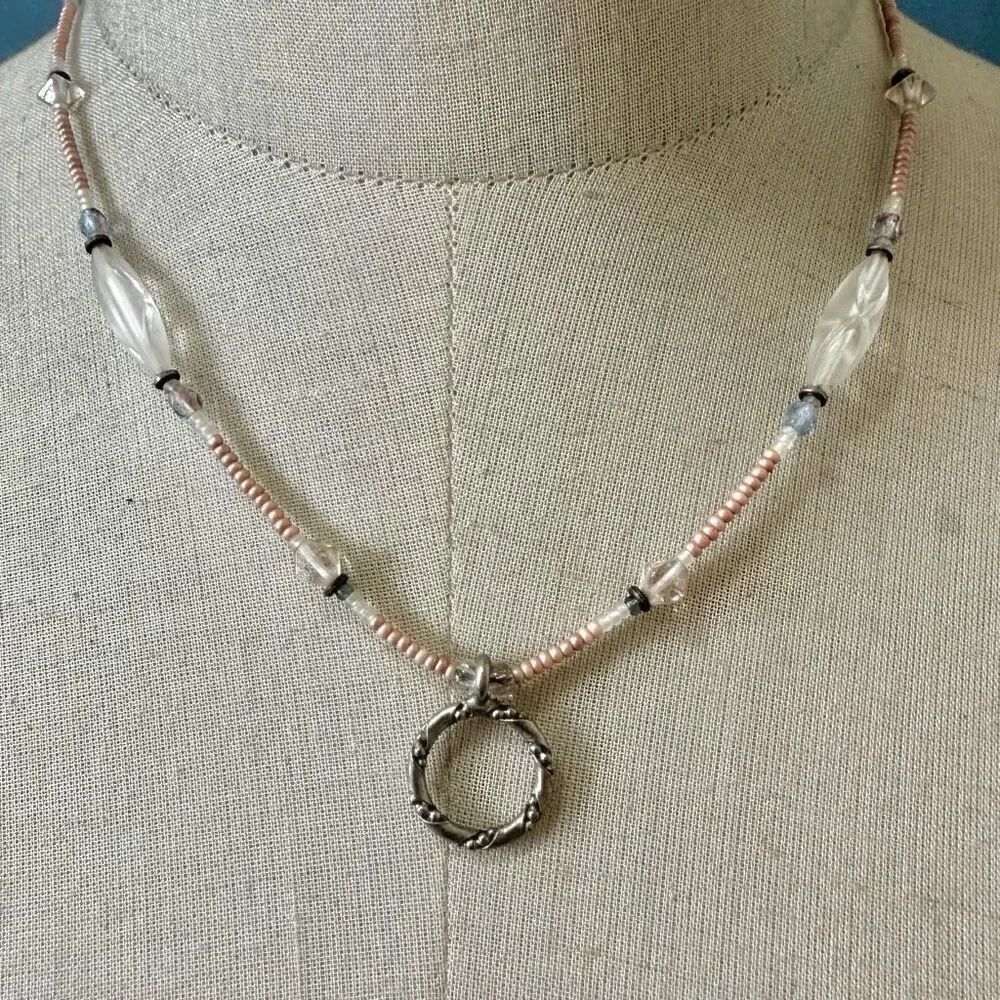 Pink beaded silver tone circle pendant necklace